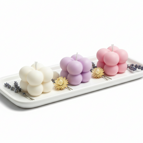 Decorative candles on a white tray . Buy now for your next gift