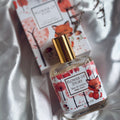 Flower story Perfume bottle and packaging with fox design on a light fabric background